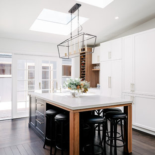 Inspiration for a large transitional galley eat-in kitchen in Hobart with a farmhouse sink, shaker cabinets, white cabinets, quartz benchtops, dark hardwood floors, with island, brown floor, white benchtop and panelled appliances.