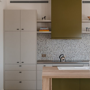 Design ideas for a mid-sized contemporary galley open plan kitchen in Other with a double-bowl sink, flat-panel cabinets, green cabinets, wood benchtops, multi-coloured splashback, porcelain floors, with island, beige floor, brown benchtop and stone slab splashback.