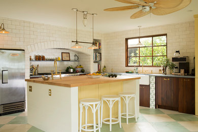 Beach style kitchen photo in Other with an island