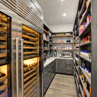 Large modern kitchen pantry pictures - Inspiration for a large modern l-shaped medium tone wood floor kitchen pantry remodel in Sacramento with shaker cabinets, dark wood cabinets, quartz countertops, stainless steel appliances and an island