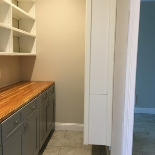 Large traditional kitchen pantry remodeling - Example of a large classic single-wall ceramic tile and gray floor kitchen pantry design in Boston with shaker cabinets, blue cabinets and wood countertops