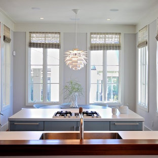 Example of a minimalist kitchen design in Jacksonville with blue cabinets and a single-bowl sink