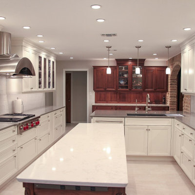 Large elegant l-shaped porcelain tile and beige floor eat-in kitchen photo in Houston with an undermount sink, recessed-panel cabinets, white cabinets, quartz countertops, white backsplash, subway tile backsplash, stainless steel appliances, an island and multicolored countertops