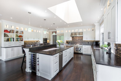 Inspiration for a large transitional u-shaped dark wood floor and brown floor eat-in kitchen remodel in Other with shaker cabinets, white cabinets, an island, a double-bowl sink, concrete countertops, brown backsplash, matchstick tile backsplash, stainless steel appliances and gray countertops