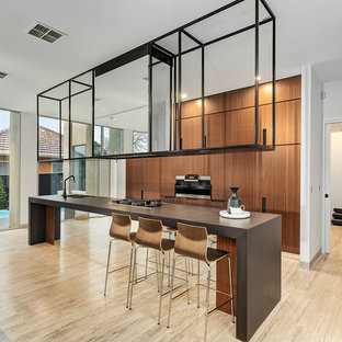 Inspiration for a large contemporary galley eat-in kitchen in Melbourne with an undermount sink, medium wood cabinets, travertine floors, with island, brown benchtop, flat-panel cabinets and beige floor.