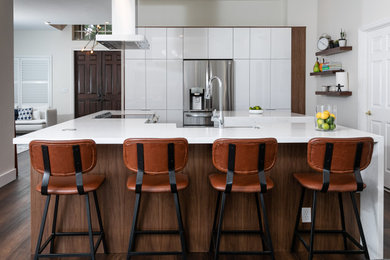 Mid-sized trendy single-wall vinyl floor, brown floor and wood ceiling kitchen photo in Miami with a farmhouse sink, flat-panel cabinets, white cabinets, quartz countertops, stainless steel appliances, two islands and white countertops