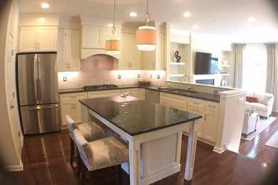 Mid-sized minimalist u-shaped dark wood floor open concept kitchen photo in Philadelphia with white cabinets, granite countertops and an island