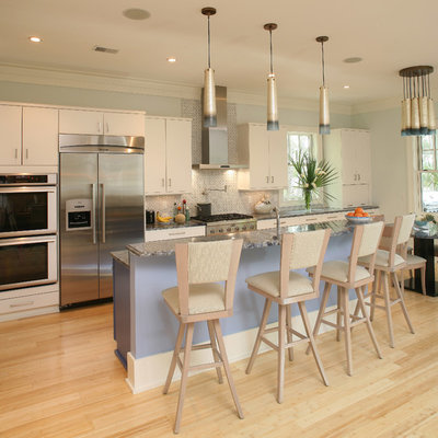 Inspiration for a transitional galley eat-in kitchen remodel in Charleston with flat-panel cabinets, white cabinets, stainless steel appliances and white backsplash