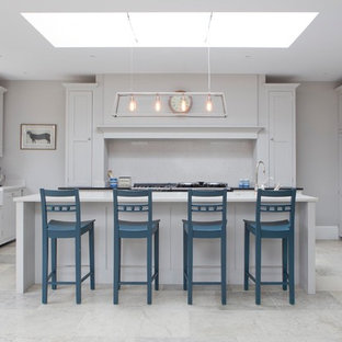 This is an example of a large classic u-shaped kitchen in Wiltshire with a submerged sink, shaker cabinets, grey cabinets, an island, grey floors, white worktops, white splashback and stainless steel appliances.