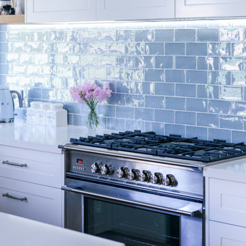 Beach style kitchen with blue tiles