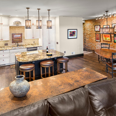 Inspiration for a mid-sized rustic l-shaped dark wood floor open concept kitchen remodel in Other with white cabinets, granite countertops, beige backsplash, stainless steel appliances, an undermount sink, shaker cabinets, brick backsplash and an island