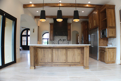 Inspiration for a large transitional l-shaped travertine floor and multicolored floor eat-in kitchen remodel in Dallas with a double-bowl sink, medium tone wood cabinets, marble countertops, multicolored backsplash, stone tile backsplash, stainless steel appliances, an island and beige countertops