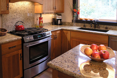 Inspiration for a rustic u-shaped eat-in kitchen remodel in Seattle with an undermount sink, recessed-panel cabinets, medium tone wood cabinets, quartz countertops, gray backsplash and stainless steel appliances