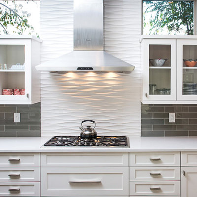 Mid-sized trendy l-shaped open concept kitchen photo in Denver with white cabinets, quartz countertops, gray backsplash, glass tile backsplash, stainless steel appliances, an undermount sink, recessed-panel cabinets and an island