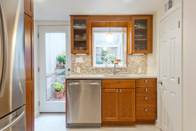 Mid-sized trendy l-shaped ceramic tile enclosed kitchen photo in DC Metro with shaker cabinets, medium tone wood cabinets, stainless steel appliances, no island, an undermount sink, matchstick tile backsplash, multicolored backsplash and laminate countertops