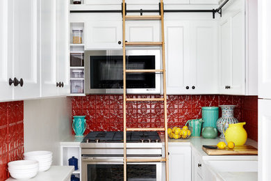 Kitchen - small transitional u-shaped multicolored floor kitchen idea in DC Metro with a farmhouse sink, white cabinets, marble countertops, red backsplash, stainless steel appliances, no island, recessed-panel cabinets and metal backsplash