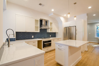 Example of a trendy light wood floor kitchen design in DC Metro with shaker cabinets, white cabinets, quartz countertops, blue backsplash, ceramic backsplash and white countertops