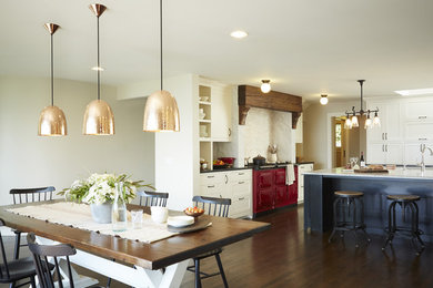 Expansive traditional u-shaped kitchen/diner in Seattle with a belfast sink, recessed-panel cabinets, white cabinets, granite worktops, stone tiled splashback, coloured appliances, dark hardwood flooring and an island.