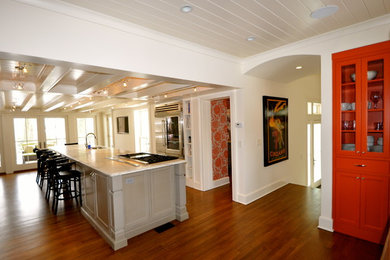 Example of a large transitional u-shaped medium tone wood floor enclosed kitchen design in New York with an undermount sink, shaker cabinets, gray cabinets, marble countertops, stainless steel appliances and an island