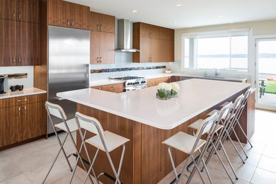 Inspiration for a large contemporary l-shaped porcelain tile open concept kitchen remodel in Seattle with an undermount sink, flat-panel cabinets, medium tone wood cabinets, quartz countertops, white backsplash, glass tile backsplash, stainless steel appliances and an island