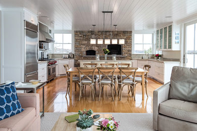 Inspiration for a large coastal u-shaped light wood floor eat-in kitchen remodel in Providence with shaker cabinets, white cabinets, an island, an undermount sink, granite countertops, metallic backsplash, metal backsplash and stainless steel appliances