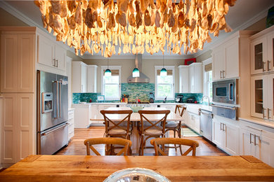 Eat-in kitchen - large coastal u-shaped medium tone wood floor and brown floor eat-in kitchen idea in Miami with an undermount sink, shaker cabinets, white cabinets, quartz countertops, green backsplash, mosaic tile backsplash, stainless steel appliances and an island