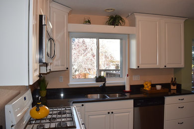 Example of a small transitional enclosed kitchen design in Denver with an undermount sink, white cabinets and white appliances