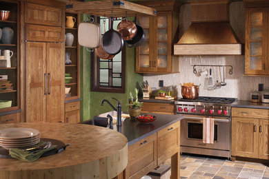 Example of a mid-sized mountain style u-shaped ceramic tile eat-in kitchen design in Tampa with recessed-panel cabinets, light wood cabinets, beige backsplash, stainless steel appliances and an island