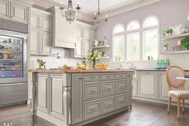 Inspiration for a large contemporary l-shaped eat-in kitchen remodel in St Louis with recessed-panel cabinets and an island