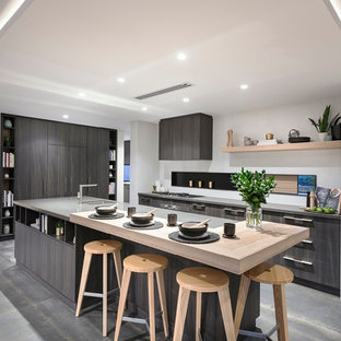 Design ideas for a contemporary l-shaped kitchen in Perth with an undermount sink, flat-panel cabinets, dark wood cabinets, panelled appliances, with island, grey floor and grey benchtop.