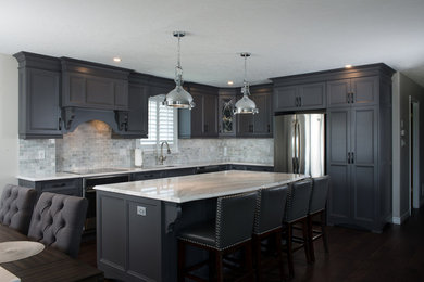 Example of a mid-sized transitional l-shaped dark wood floor eat-in kitchen design in Toronto with a single-bowl sink, recessed-panel cabinets, gray cabinets, quartz countertops, ceramic backsplash, stainless steel appliances and an island