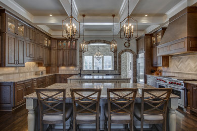 Inspiration for a huge farmhouse u-shaped dark wood floor and brown floor eat-in kitchen remodel in Chicago with an undermount sink, beaded inset cabinets, medium tone wood cabinets, granite countertops, beige backsplash, matchstick tile backsplash, stainless steel appliances and two islands