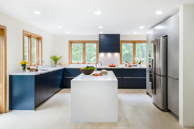 Mid-sized minimalist l-shaped porcelain tile and beige floor eat-in kitchen photo in Boston with an undermount sink, flat-panel cabinets, gray cabinets, quartz countertops, stainless steel appliances, an island and white countertops