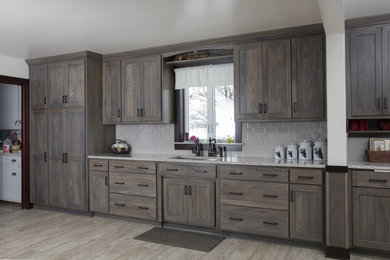 Mid-sized arts and crafts l-shaped porcelain tile and beige floor kitchen photo in Cleveland with shaker cabinets, distressed cabinets, white backsplash, ceramic backsplash and no island