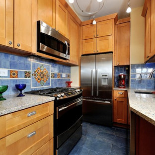Small mediterranean u-shaped separate kitchen in New York with raised-panel cabinets, light wood cabinets, blue splashback, ceramic splashback, stainless steel appliances, recycled glass benchtops, porcelain floors and an undermount sink.