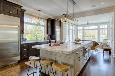 Inspiration for a large transitional u-shaped dark wood floor kitchen remodel in New York with a single-bowl sink, shaker cabinets, gray cabinets, quartzite countertops, gray backsplash, glass tile backsplash, stainless steel appliances and two islands