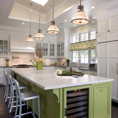 Example of a large classic u-shaped dark wood floor kitchen design in San Diego with a farmhouse sink, beaded inset cabinets, white cabinets, white backsplash, subway tile backsplash, stainless steel appliances, an island and marble countertops