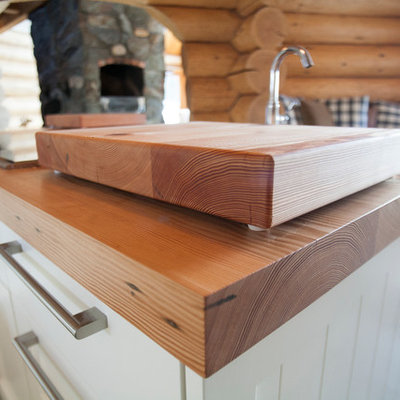 Inspiration for a large rustic u-shaped slate floor eat-in kitchen remodel in Vancouver with a farmhouse sink, shaker cabinets, white cabinets, wood countertops, stainless steel appliances and an island