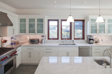 Mid-sized trendy u-shaped porcelain tile open concept kitchen photo in New York with an undermount sink, white cabinets, granite countertops, stone slab backsplash, stainless steel appliances, an island, shaker cabinets and white backsplash