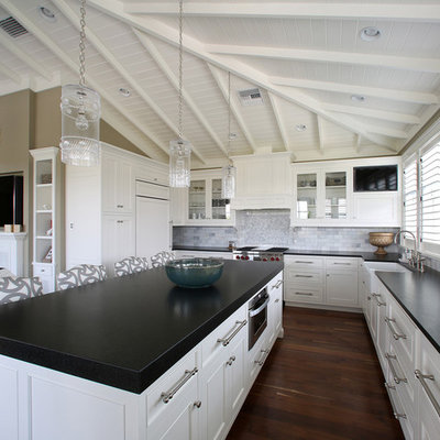 Island style l-shaped open concept kitchen photo in Tampa with a farmhouse sink, recessed-panel cabinets, white cabinets, gray backsplash and subway tile backsplash