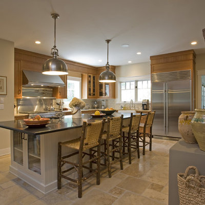 Example of a large mountain style l-shaped ceramic tile enclosed kitchen design in New York with stainless steel appliances, a farmhouse sink, flat-panel cabinets, medium tone wood cabinets, granite countertops, white backsplash and subway tile backsplash