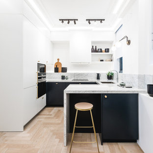 Inspiration for a small contemporary u-shaped kitchen in London with flat-panel cabinets, marble worktops, marble splashback, stainless steel appliances, light hardwood flooring, a breakfast bar, beige floors, grey worktops, a submerged sink, black cabinets and grey splashback.