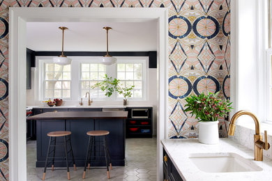 Example of a mid-sized trendy l-shaped cement tile floor and gray floor kitchen pantry design in Philadelphia with a single-bowl sink, shaker cabinets, blue cabinets, quartz countertops, white backsplash, ceramic backsplash, stainless steel appliances, an island and white countertops