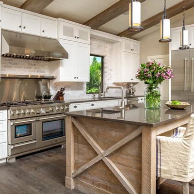 Elegant galley dark wood floor kitchen photo in Tampa with an undermount sink, shaker cabinets, white cabinets, stainless steel appliances and an island