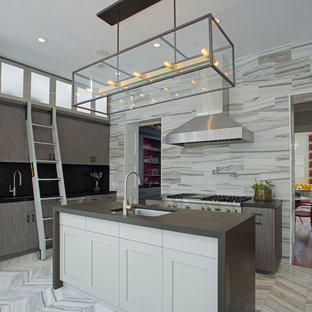 This is an example of a mid-sized contemporary single-wall eat-in kitchen in Atlanta with an undermount sink, flat-panel cabinets, grey cabinets, stainless steel appliances, marble floors, with island, grey splashback, stone tile splashback, solid surface benchtops and grey floor.