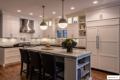 Transitional eat-in kitchen photo in Chicago with shaker cabinets, white cabinets, paneled appliances and an island