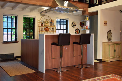 Eat-in kitchen - mid-sized modern u-shaped porcelain tile and beige floor eat-in kitchen idea in New York with an undermount sink, flat-panel cabinets, medium tone wood cabinets, quartz countertops, white backsplash, stainless steel appliances, an island and white countertops