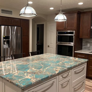 Photo of a mid-sized transitional u-shaped eat-in kitchen in Phoenix with a drop-in sink, shaker cabinets, white cabinets, granite benchtops, multi-coloured splashback, glass tile splashback, stainless steel appliances, porcelain floors, multi-coloured floor, turquoise benchtop and with island.
