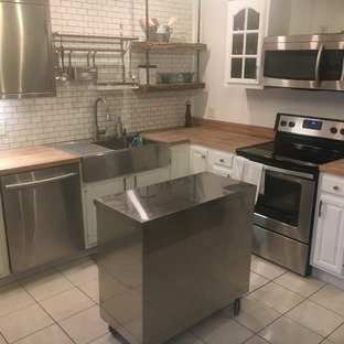 Small industrial l-shaped kitchen in Portland Maine with a single-bowl sink, raised-panel cabinets, white cabinets, zinc benchtops, white splashback, subway tile splashback, stainless steel appliances, ceramic floors and yellow floor.