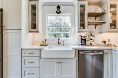 Inspiration for a mid-sized transitional galley medium tone wood floor and brown floor eat-in kitchen remodel in Birmingham with a farmhouse sink, shaker cabinets, gray cabinets, quartz countertops, white backsplash, subway tile backsplash, stainless steel appliances, a peninsula and white countertops
